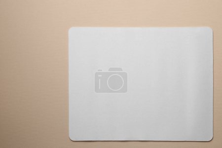 Photo for One mouse pad on beige background, top view. Space for text - Royalty Free Image