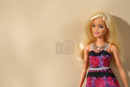 Mykolaiv, Ukraine - September 4, 2023: Beautiful Barbie doll wearing necklace on beige background, space for text