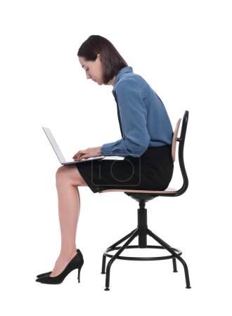Woman with poor posture sitting on chair and using laptop against white background