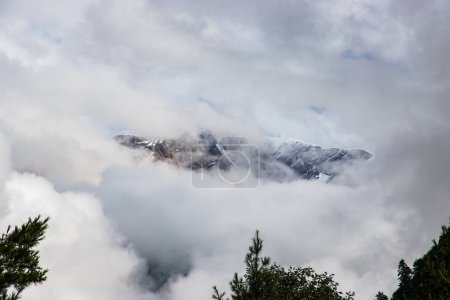 Téléchargez les photos : Sombre et dramatique Himalaya Mountain dans les nuages cachés par le brouillard au Népal - en image libre de droit