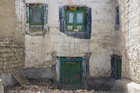 Photo for Old and Traditional White House with Tibetan Decor Windows and Door in Lo Manthang, Mustang, Nepal - Royalty Free Image