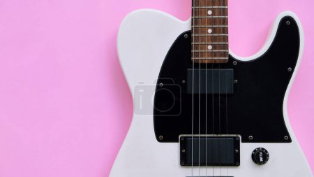 Photo for Black and white electric guitar on a pink background. Top view. - Royalty Free Image