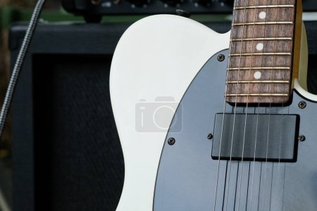 Electric guitar on the background of the guitar amplifier. Close-up.