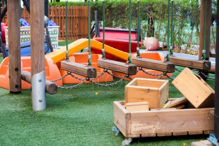 Photo for Deserted playground with various equipment and toys on green synthetic grass - Royalty Free Image