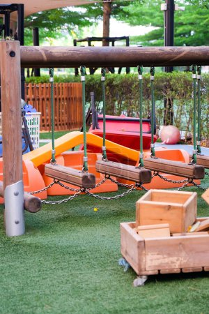 Photo for Empty playground with various equipment and toys on green synthetic grass - Royalty Free Image