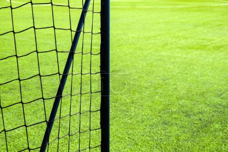 Photo for Soccer goal net on green grass field background with copy space. - Royalty Free Image