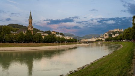 Salzburg, Austria, August 15, 2022. Golden hour shot towards the historic center. Highlighted is the fort at the top of the hill which dominates the landscape. Large format panoramic photo
