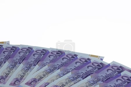 Photo for A plan view spread of twenty pound notes sterling isolated on a white background. - Royalty Free Image