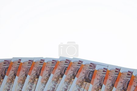 Foto de A plan view spread of ten pound notes sterling isolated on a white background. - Imagen libre de derechos
