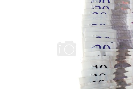 Photo for A plan view close up spread of ten and twenty pound notes sterling isolated on a white background - Royalty Free Image