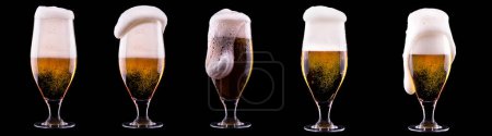Frosty glass of light beer isolated on a black background