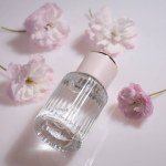 Perfume bottle, glass container for perfumery on white, copy space