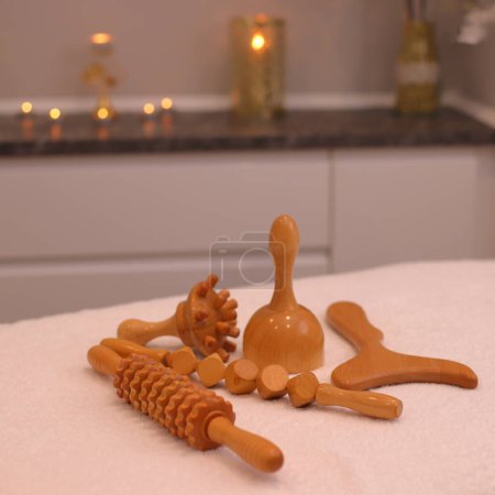 Wooden massage therapy tools on spa salon massaging table, anti cellulite health care concept