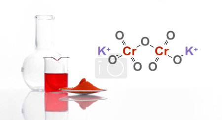 Kaliumdichromat in chemischem Uhrglas neben roter Flüssigkeit im Becher und Flachbodenkolben. Die Struktur einer chemischen Verbindung ist auf der Seite dargestellt.
