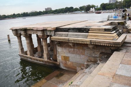 Photo for Architectural Heritage Ghat with intricate carvings in stone in Kankaria Lake, was built in the 15th century 1451 by Emperor Qutb-ud-Din Ahmad Shah II, Ahemdabad Gujarat, Indi - Royalty Free Image