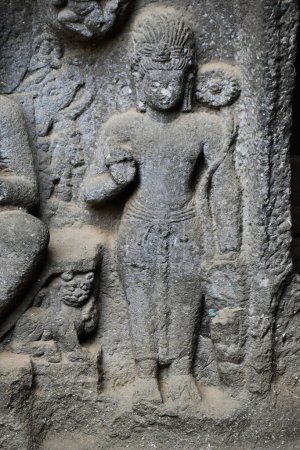 Photo for Bas relief Sculpture of Buddhism Avalokitesvara, carved in a stone on outer wall of Chaitya Hall at Karla Buddhist Caves, these Caves was constructed between 50 and 70 CE, and 120 CE, located near the Karla, Lonavala in Pune Dist. Maharashtra, India. - Royalty Free Image