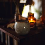 Moody vibe with a tea mug and a candle