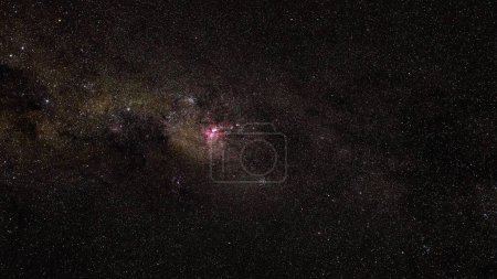 Photo for Southern night sky, many stars with milky way around Crux and Vela constellation, red purple Great Carina Nebula in middle visible. - Royalty Free Image