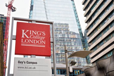 Photo for London, United Kingdom - February 01, 2019: Red and white King's college sign at famous research university, blurred modern buildings in background - Royalty Free Image