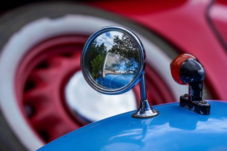 Photo for Rear mirror mounted on front fender of blue color vintage car, closeup detail - Royalty Free Image