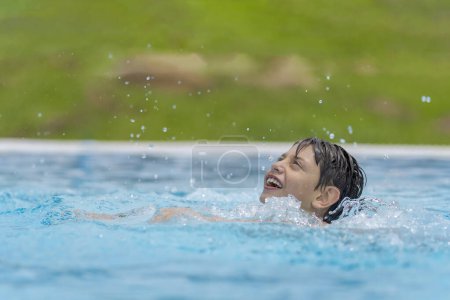 Photo for Cute boy swimming, enjoying the aqua park - Royalty Free Image