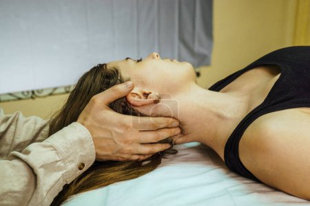 Photo for A CST treatment session for a woman, Osteopathic Manipulation an - Royalty Free Image