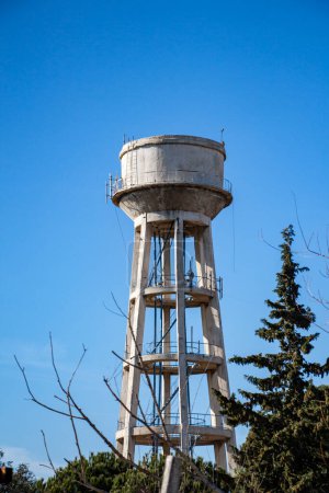 Water tower against blue sky. Water tower on a sky background. 