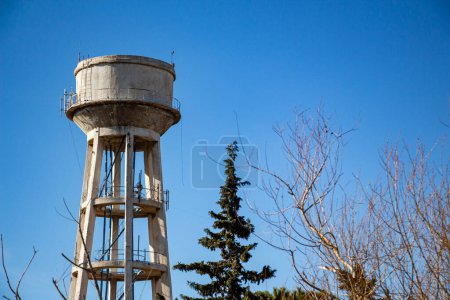 Water tower against blue sky. Water tower on a sky background. 