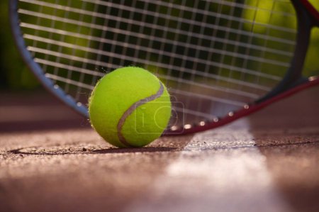 Foto de Tennis scene with ball, racquet and hard court surface corner line in low angle view - Imagen libre de derechos