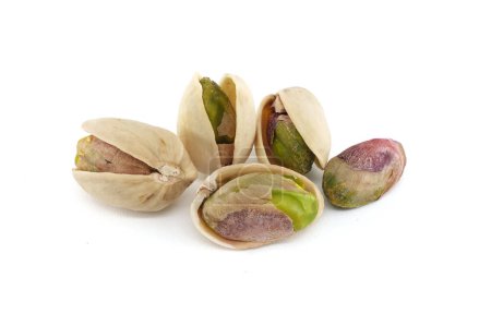 Pistachios in-shell and others peeled exposing the green nuts inside isolated on white background
