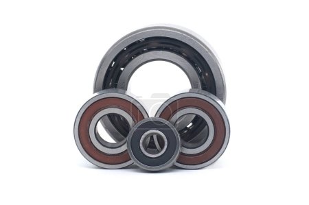 Deep groove ball bearings with rubber seals, each of different sizes, aligned vertically isolated on white background