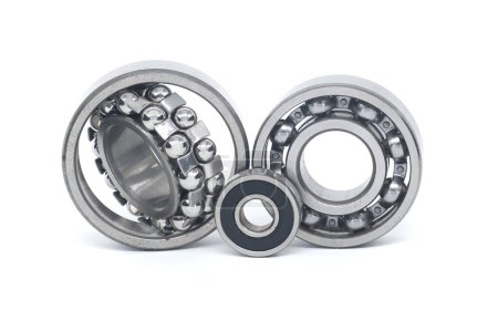 Double row roller bearing near deep groove ball bearing without seal and ball bearing with rubber seal isolated on white background