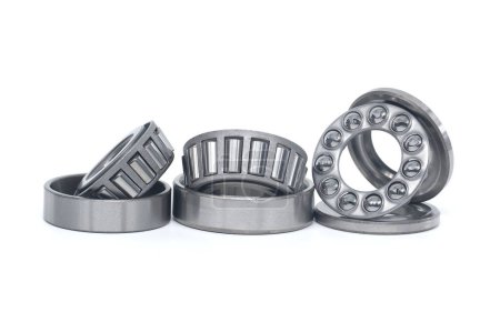 Single row tapered roller bearings and thrust ball bearings isolated on white background
