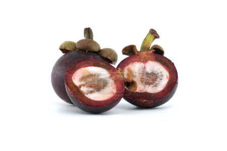 Whole and halved mangosteen fruits display their white inner flesh, speckled with dark purple spots and featuring two discernible black seeds, set against a white background