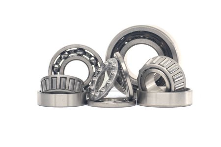 Array of bearings of varying sizes and types, including roller bearings and ball bearings isolated on a white background