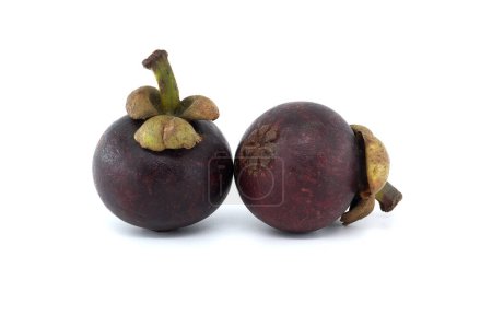 Two whole purple mangosteen fruits isolated on white background, Garcinia mangostana