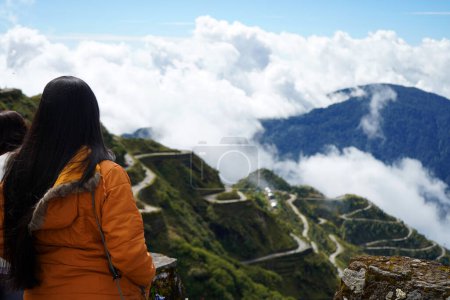 Photo for Girl Tourist getting the View of Zig Zag Road of Old Silk Route East Sikkim - Royalty Free Image