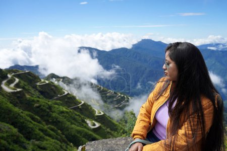 Photo for Teenage girl Tourist taking the view of Zig Zag Road in Old Silk Route Sikkim in her Vacation - Royalty Free Image
