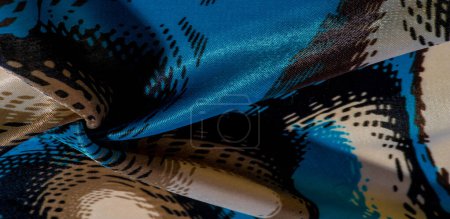 Téléchargez les photos : Tissu de soie. Couleurs : bleu, noir, violet, beige. texture, panorama en soie, fond avec beau flou doux. L'abstraction - en image libre de droit
