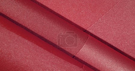 Téléchargez les photos : Le tissu de soie est rouge rubis. texture de tissu de soie coloré - peut être utilisé comme fond - en image libre de droit