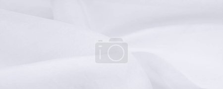 Photo for Blurred, white silk fabric. Organza fabrics are transparent and very light, but at the same time durable and with clear draperies. For large undertakings such as your projects - Royalty Free Image