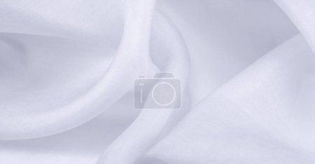 Tissu de soie blanc flou. Les tissus organza sont transparents et très légers, mais en même temps durables et avec des draperies claires. Pour les grandes entreprises telles que vos projets