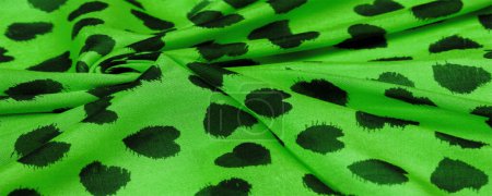 silk fabric in green. print of black hearts, texture background, pattern, postcard