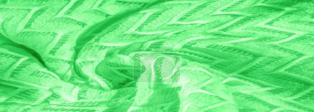 grüner Stoff, vielschichtige Seidenspitze, hochwertiger glatter Winter-Strickschal. Textur, Hintergrund, Muster, Seide