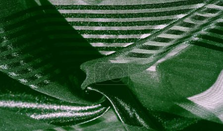 Silk fabric. light transparent silk fabric with stripes of different sizes, green. texture, background, pattern