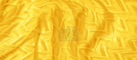 gelber Stoff, vielschichtige Seidenspitze, hochwertiger glatter Winter-Strickschal. Textur, Hintergrund, Muster, Seide