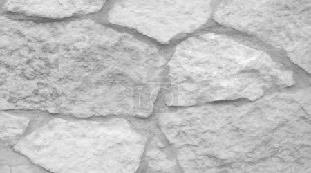 Fond flou. La texture de la pierre encastrée dans le mur, blanc