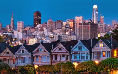 Photo for Evening, Painted Ladies Victorian houses in Alamo Square and a view of the San Francisco skyline and skyscrapers. Photo processed, in pastel colors - Royalty Free Image