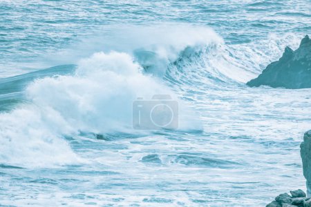 Wave splashing close-up. Crystal clear sea water, in the ocean in San Francisco Bay, blue water pastel colors.