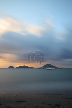 Photo for Seascape at sunshine. Lighthouse and sailings on the coast. Seaside town of Turgutreis and spectacular sunshine. Long Exposure shoot. tranquility scene. - Royalty Free Image
